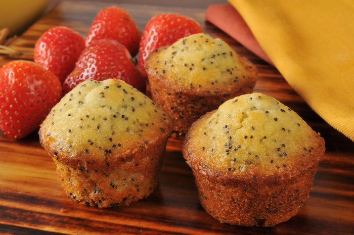 gluten free double True Lemon poppy seed muffins on a wooden tables