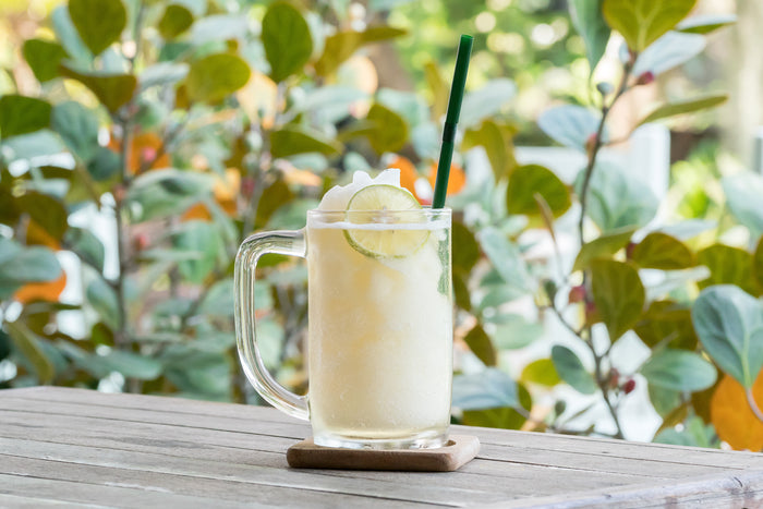 Glass of Frozen Lemonade Sitting outside.