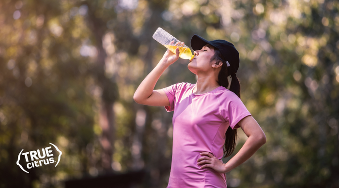 woman in pink drinking True Lemon after a work out