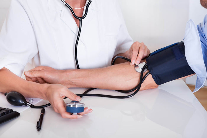 a doctor taking a patient's blood pressure