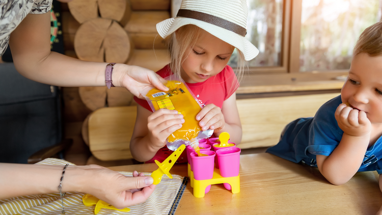 Kids helping their mom make Healthy Homemade Popsicles.