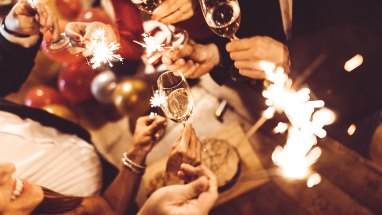 Friends at a New Years Party with sparklers. 