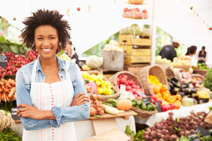 women smiles at a farmers market