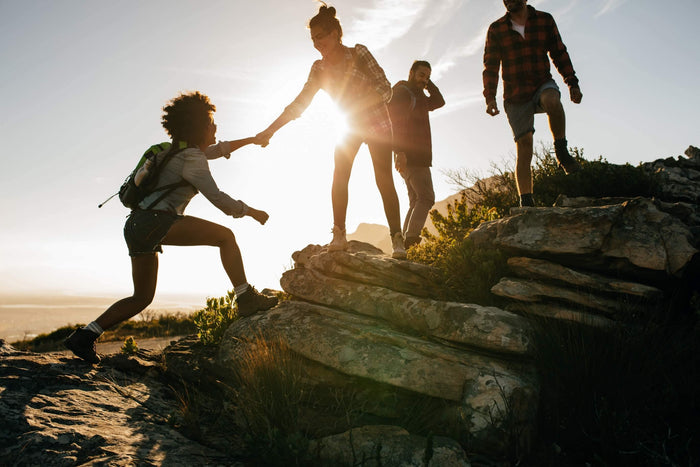 group of friends go on a fun hike during sunset