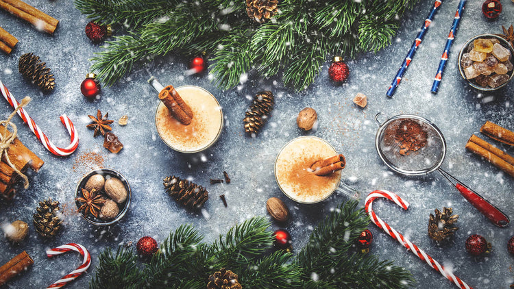 Table with array of holiday decorations and winter cocktails.