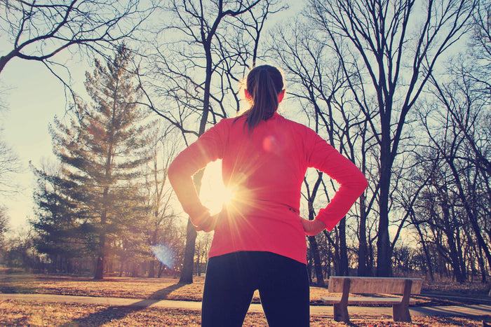 women standing still after a run through the woods