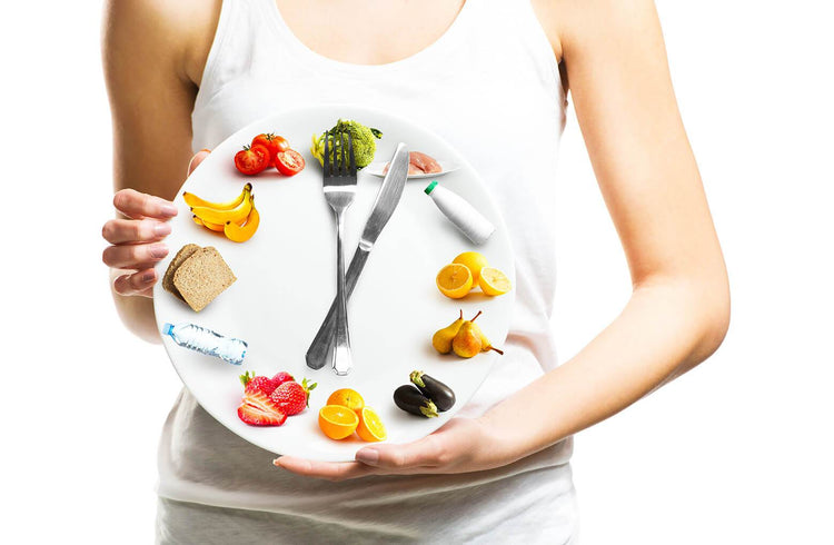 plate make to look like a clock with fruit placed in a circle around edge to represent the numbers, knife and fork used as second and minute hands