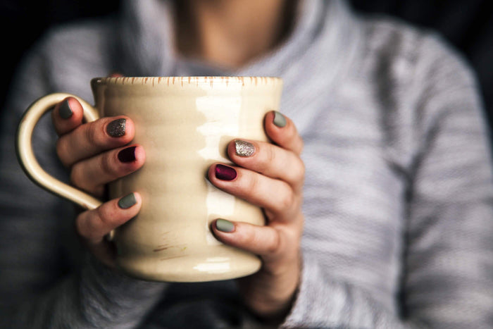 women holds a cup of tea