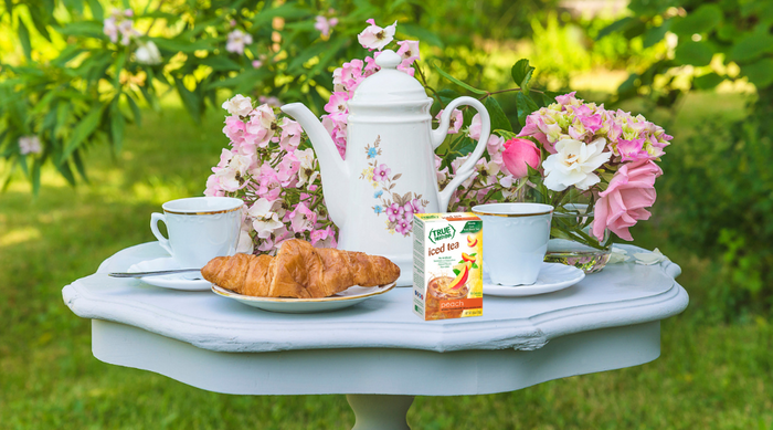 Tea set on a white table on a summer afternoon with True Lemon