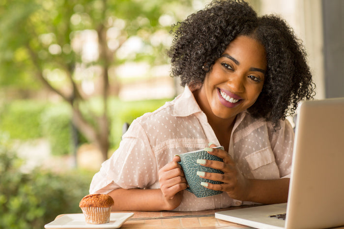 Woman working outside while drinking a cup of tea