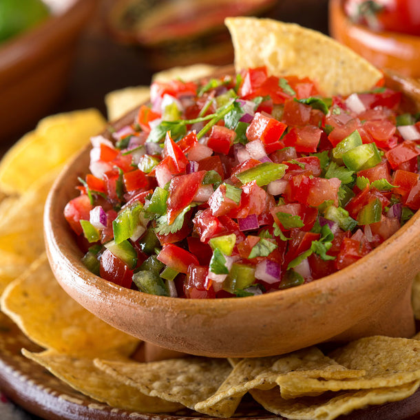 A bowl of homemade salsa with True Lime and tortilla chips.