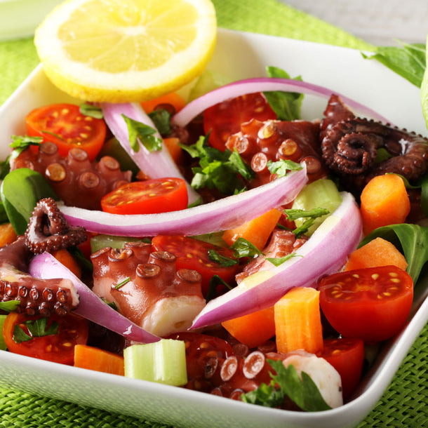 An octopus-leg salad with onions, tomatoes, and a dash of True Lemon Pepper Spice Blend.